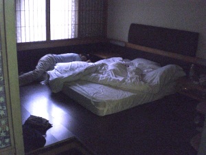 Floor sleeping in Taipei - one on the queen-sized mattress, one on the cot-sized mattress.
